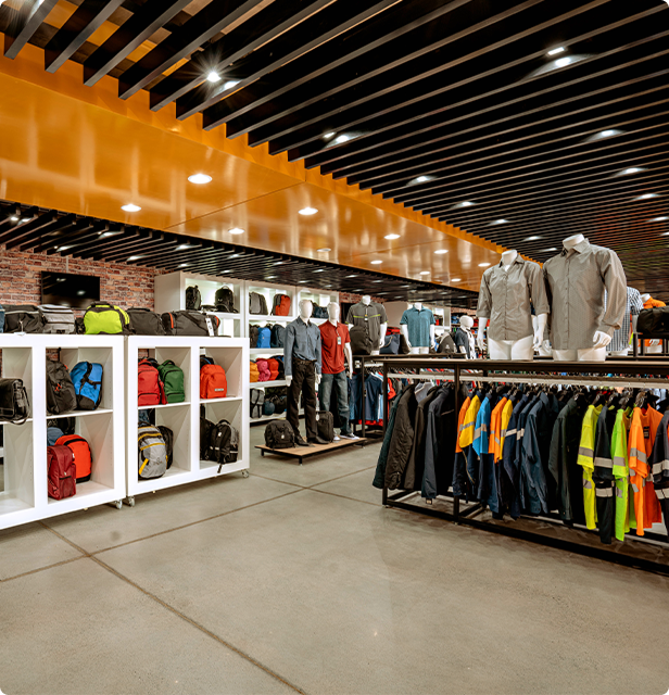Barron showroom featuring corporate apparel, workwear, and branded merchandise including bags, shirts, and uniforms on display