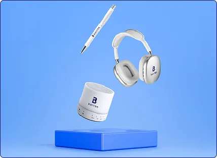 Modern branded tech gift set including wireless headphones, portable speaker, and pen with Barron logo — premium corporate tech accessories on blue background